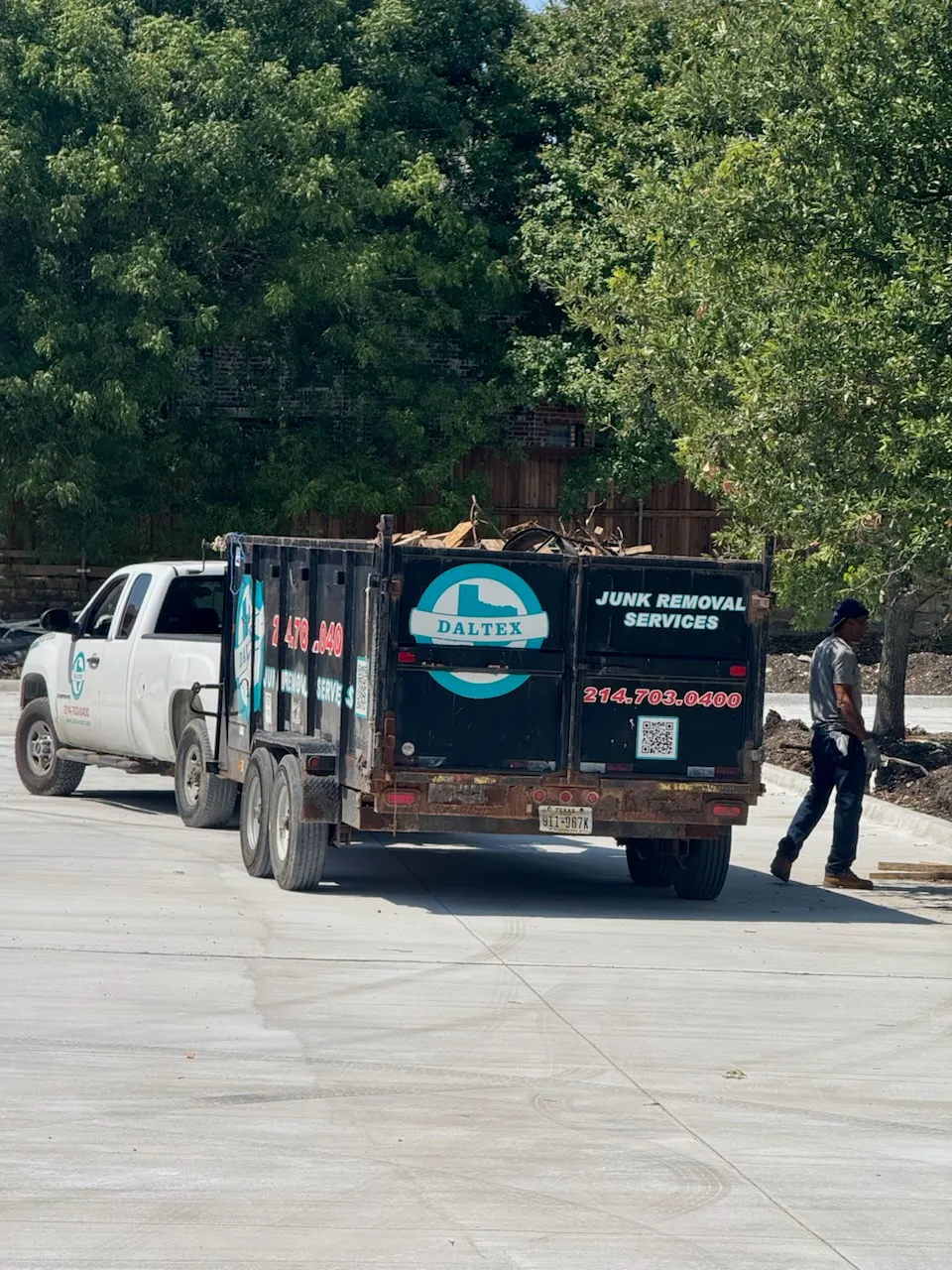 Daltex junk removal trailer and service truck loaded with debris on a commercial job